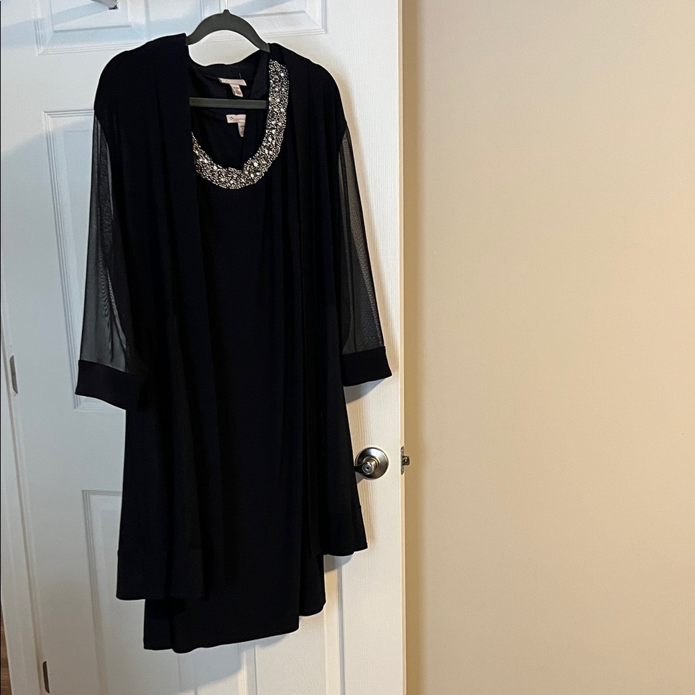 Elegant Black Women's Dress with Embellished Neckline and Jacket.